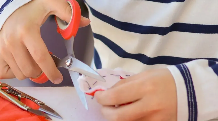 A child creating a colourful piece of art